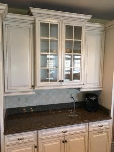 Kitchen cabinets in simply white with a brown bronze glaze.