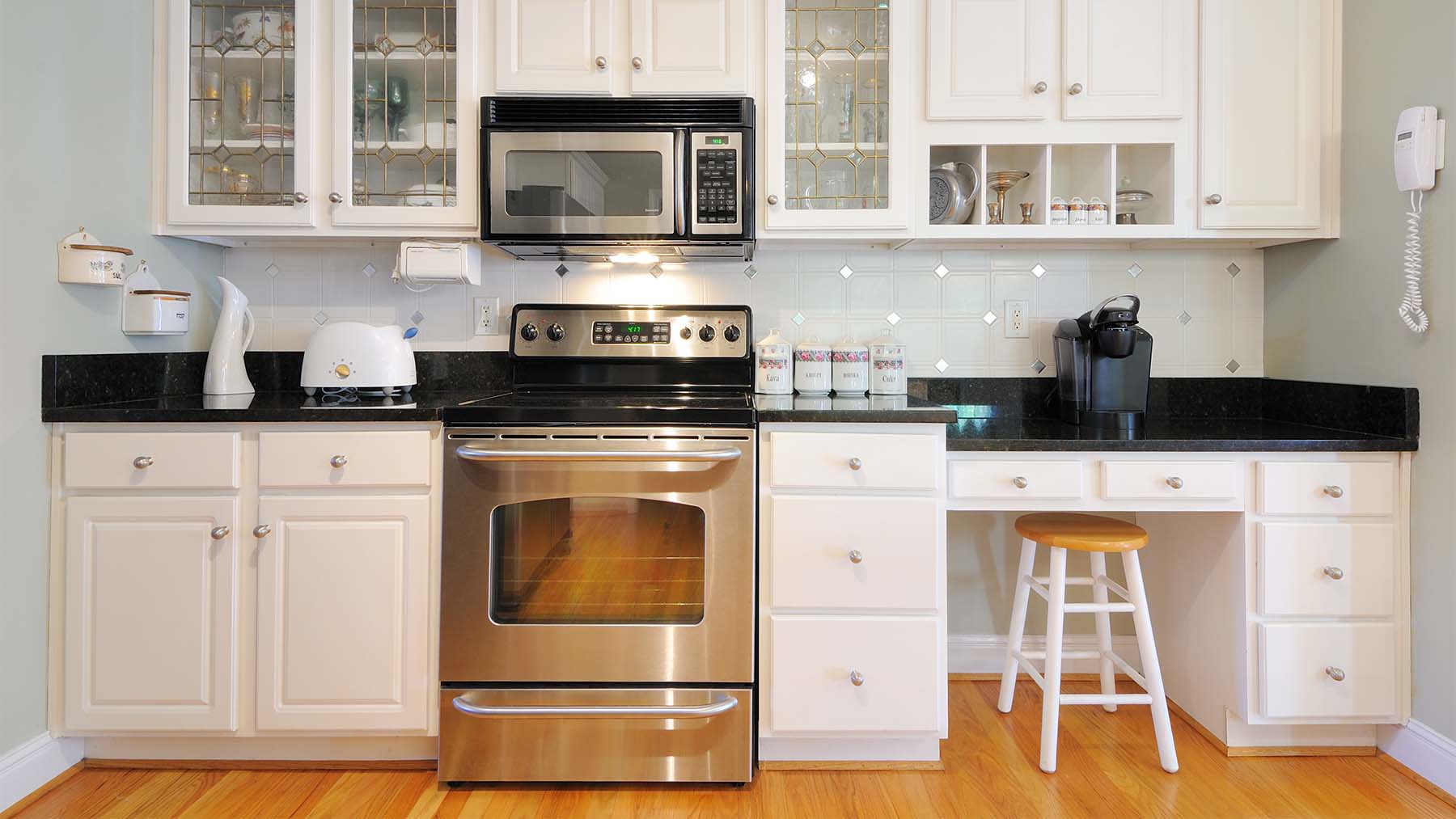 a kitchen with repainted cabinets - at Richie's, we have 45 years of combined experience refinishing and repainting cabinets